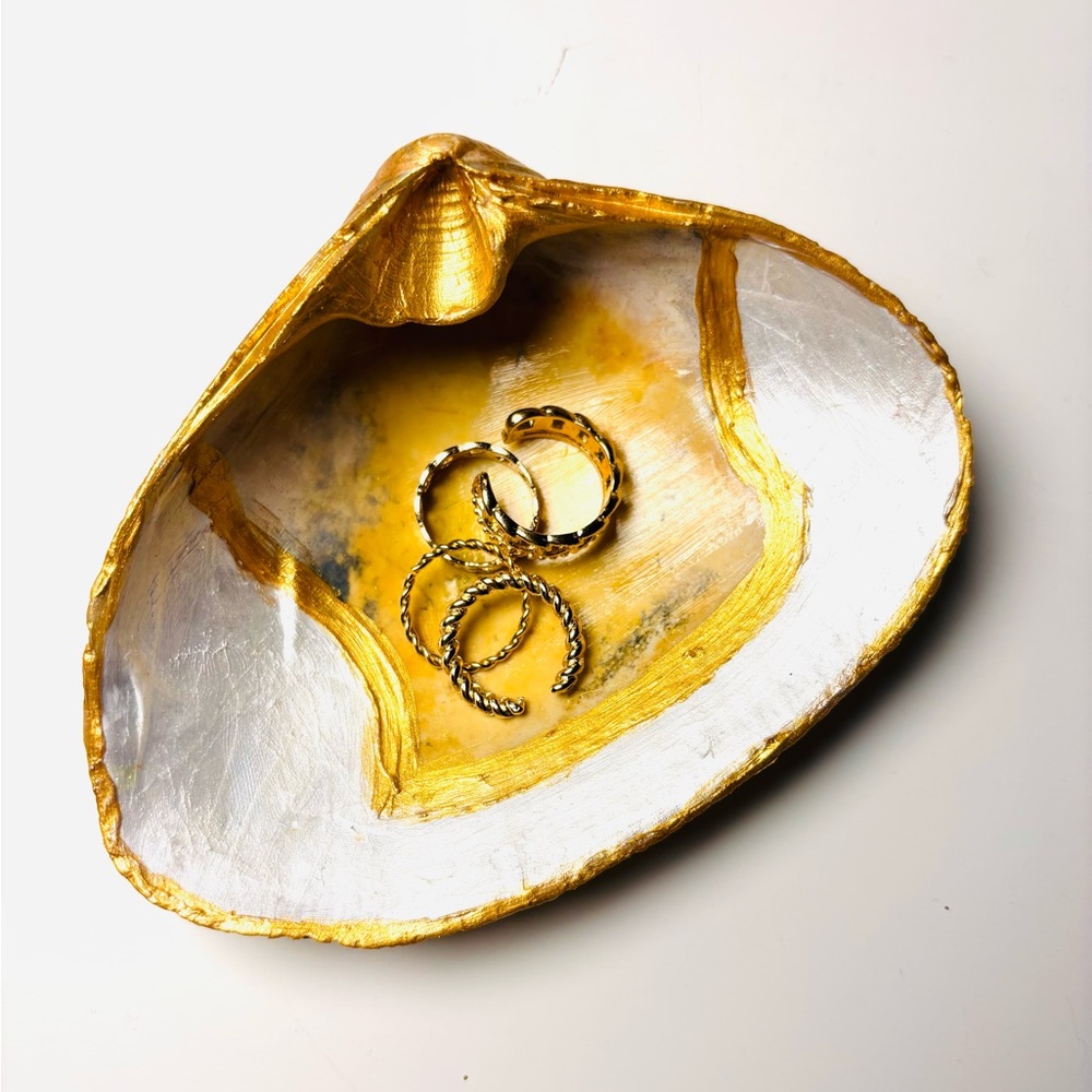 Handmade shell ring dish with painted design.